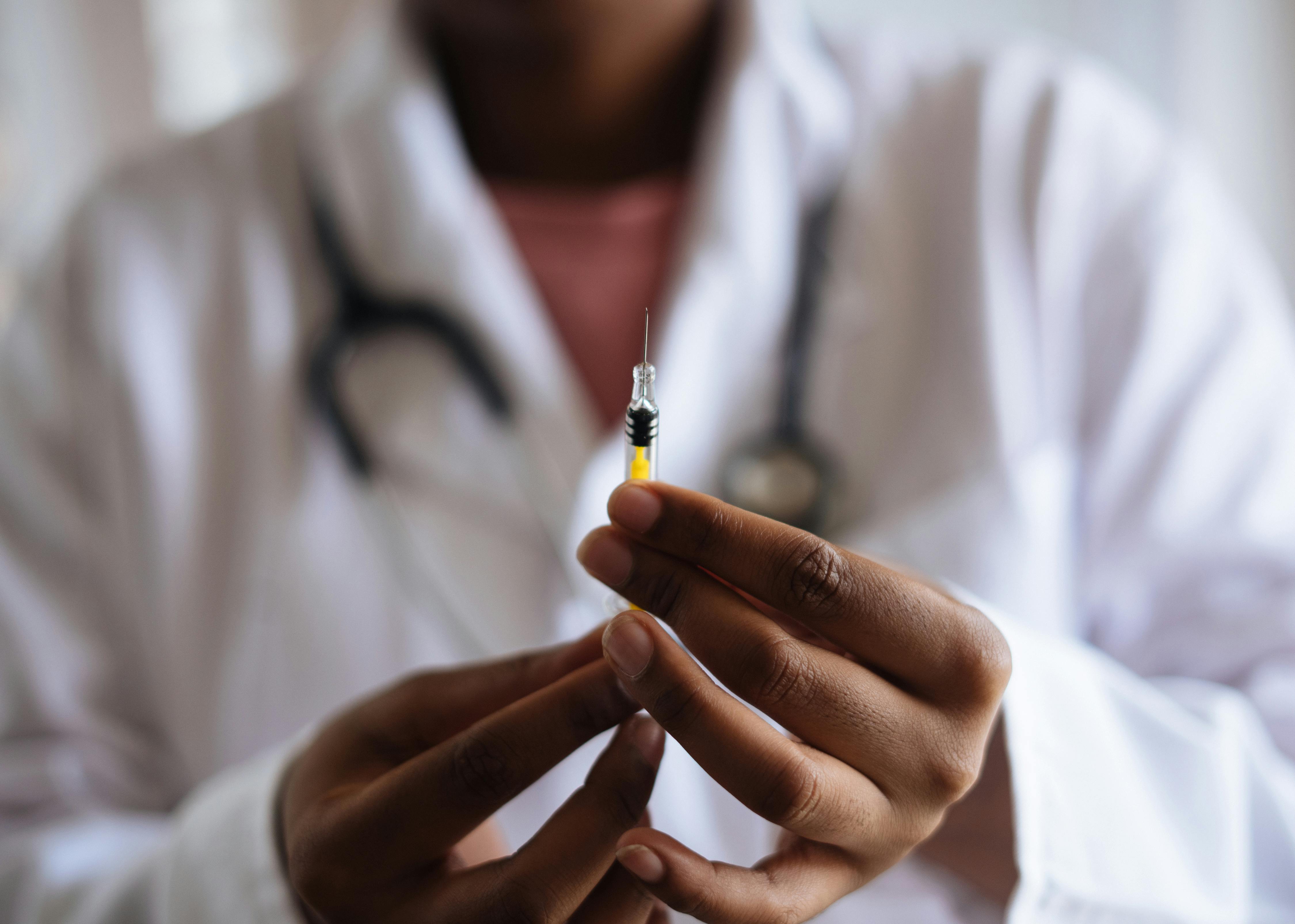 Doctor holding injection