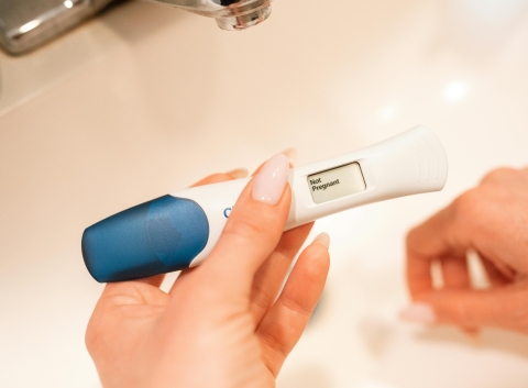 hands holding pregnancy test
