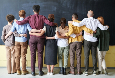 Diverse group of young adults standing together.