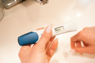 hands holding pregnancy test